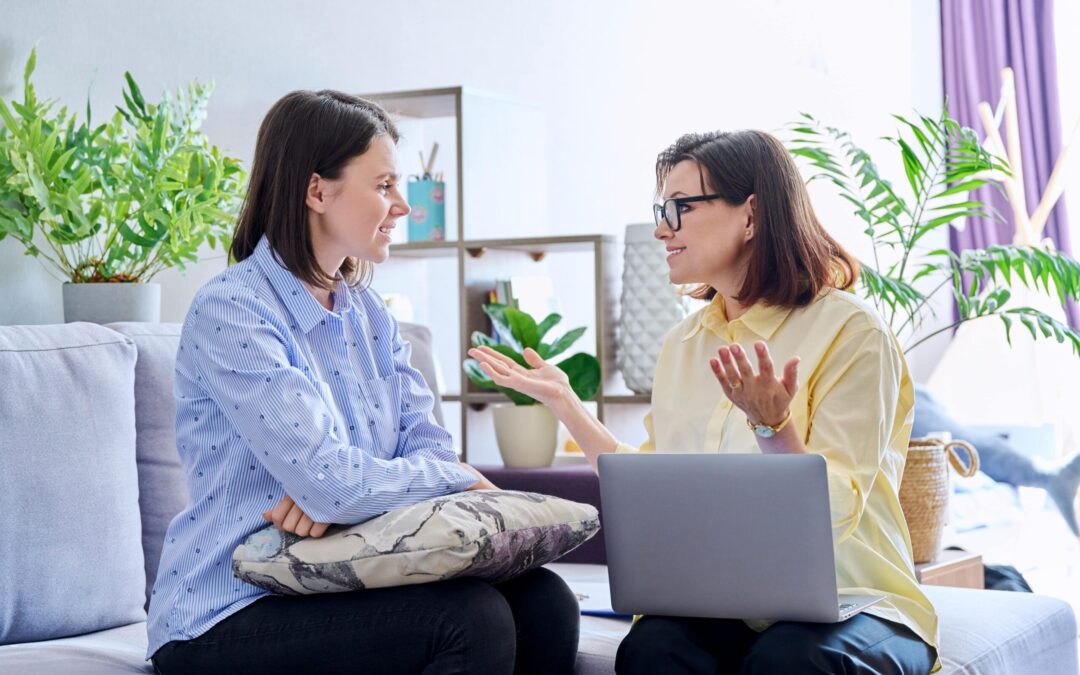 Smiling adult talking to a therapist – Mental Health Symptoms Can Be Managed